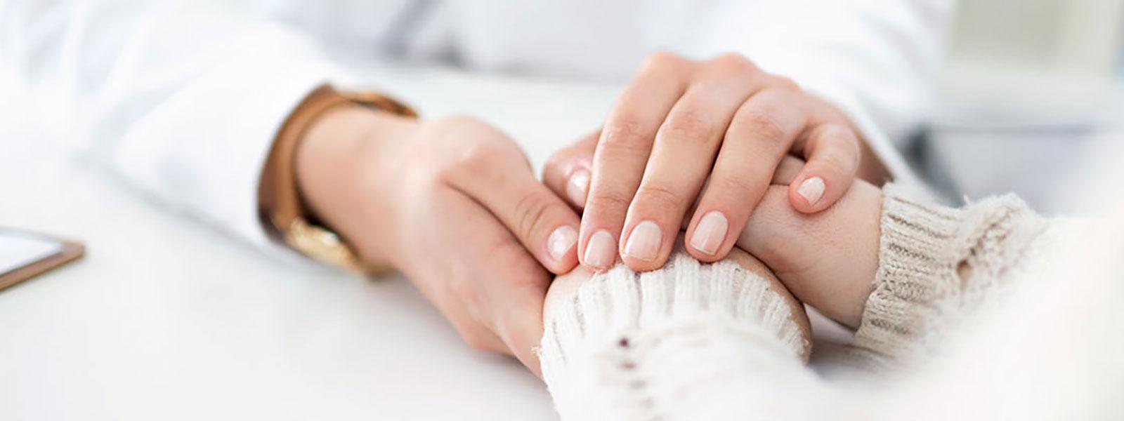 Health Provider holding hands with patient